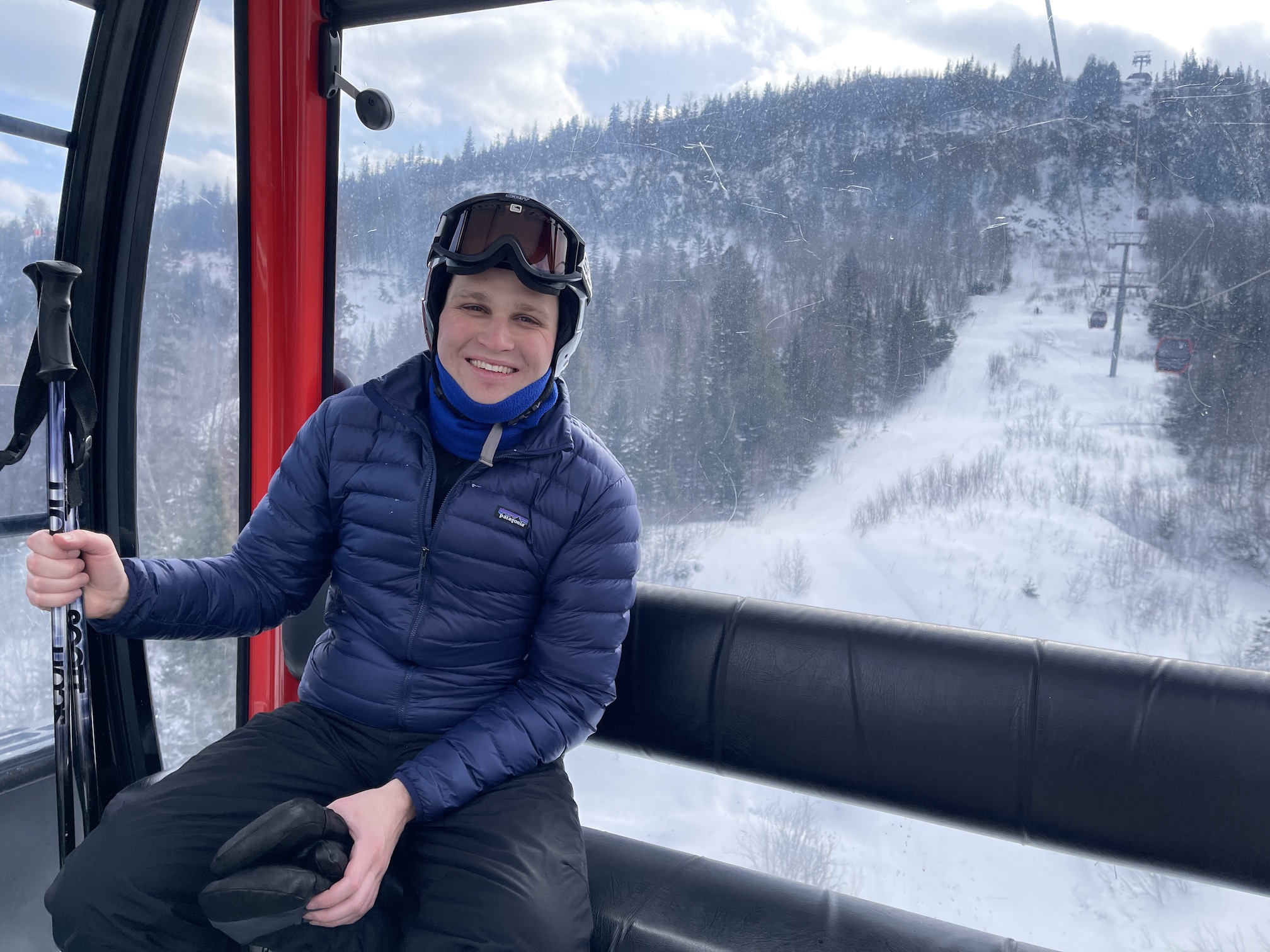 Brian sitting in a gondola at Lutsen Mountains Ski Resort